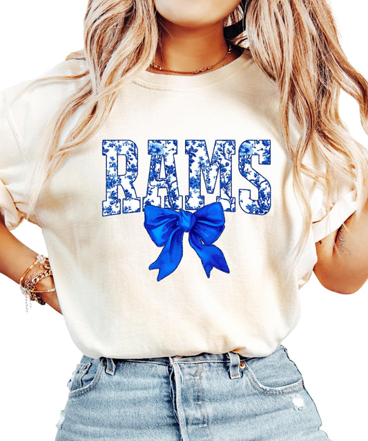 Close-up detail of blue floral Rams letters with oversized bow graphic on women's shirt
