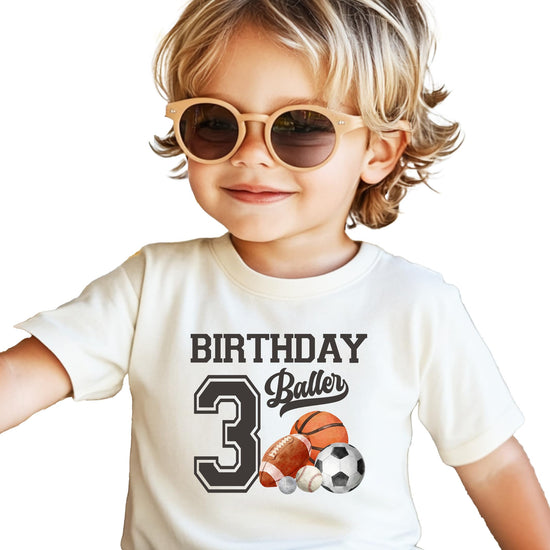 Close-up of Birthday Baller number 3 print on black toddler t-shirt