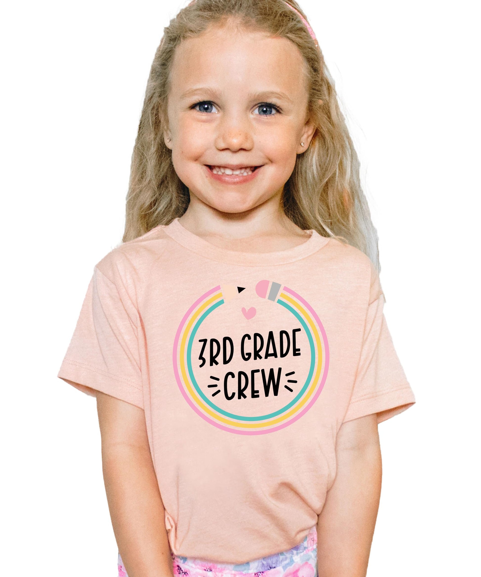 Detail shot of soft mauve fabric and colorful pencil graphic on kids back to school crew tee