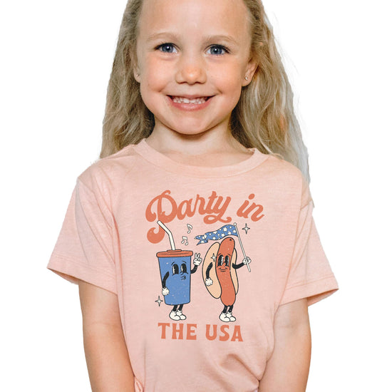 Person wearing pink 4th of July hotdog shirt with patriotic design