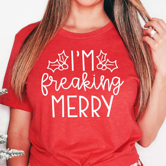 Close-up of I'm Freaking Merry holiday graphic print on soft green women's Christmas shirt