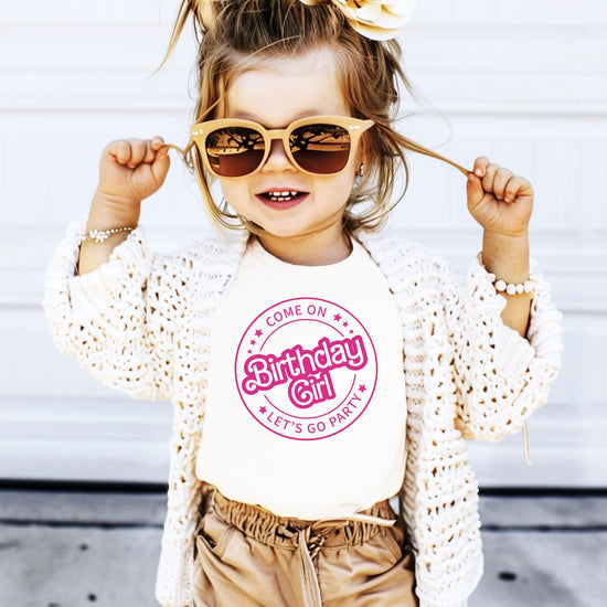 Close-up of Come On Let's Go Party birthday girl shirt showing vibrant retro pink graphic print