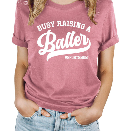Busy Raising a Baller black t-shirt for women, front view on model