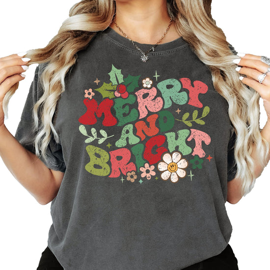 Women modeling Merry and Bright holiday graphic tee in ivory, casual festive style