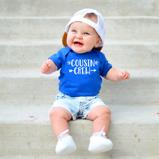 Toddler modeling white Cousin Crew t-shirt in natural pose