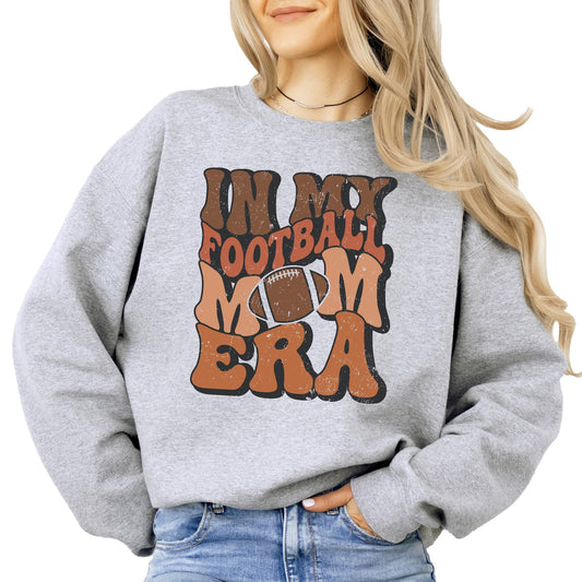 Close-up of retro distressed Football Mom Era graphic print on white sweatshirt