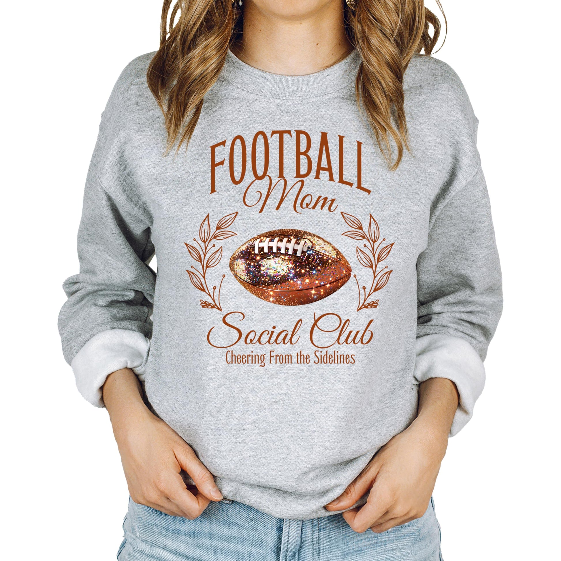 Model wearing Football Mom Social Club pullover sweatshirt in gray with glitter football print