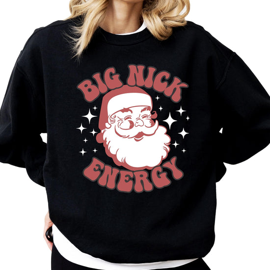 Close-up of retro Santa Big Nick Energy graphic print on black women's sweatshirt