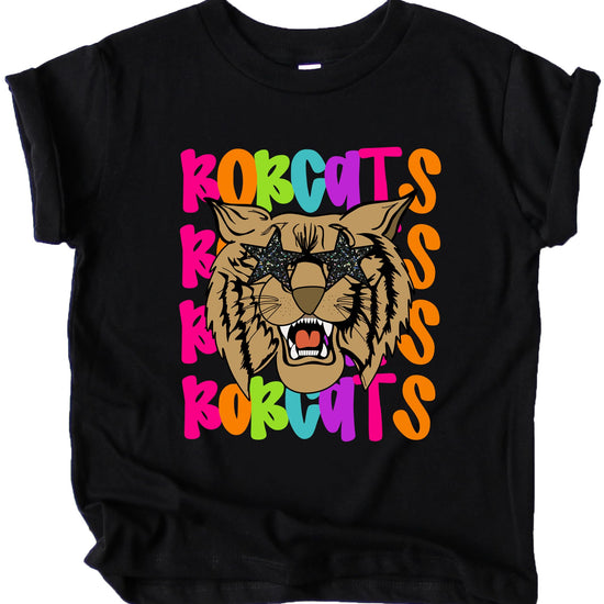 Flat lay of Bobcats school spirit tee showing full design with colorful retro mascot graphic
