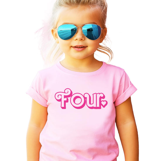 Close-up of heart and 'four' graphic on pink birthday shirt for girls