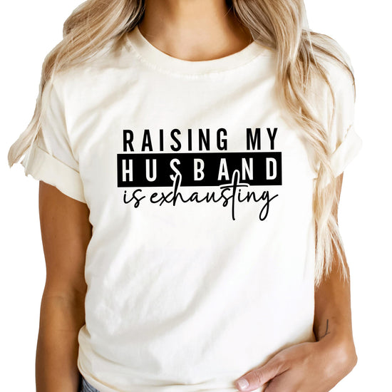 Flat lay of women's funny graphic tee in heather blue for wives and marriage humor