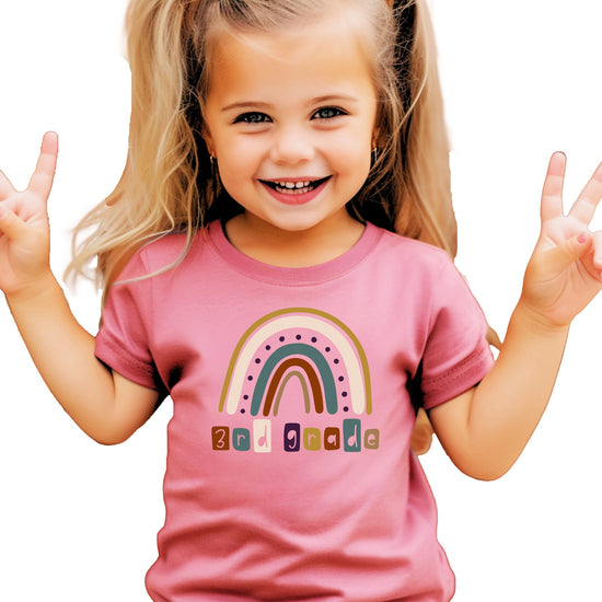 Kids pink tee with colorful rainbow and 3rd Grade First Day of School graphic print
