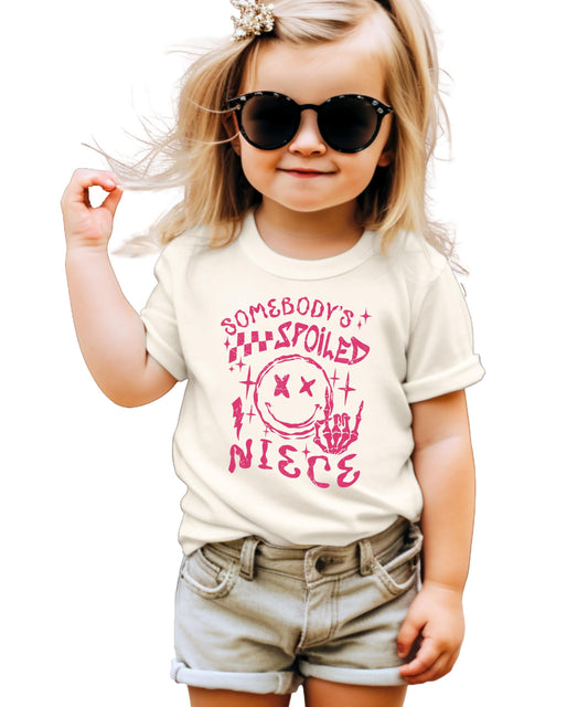 Pink Somebody's Spoiled Niece youth girls t-shirt with black text graphic