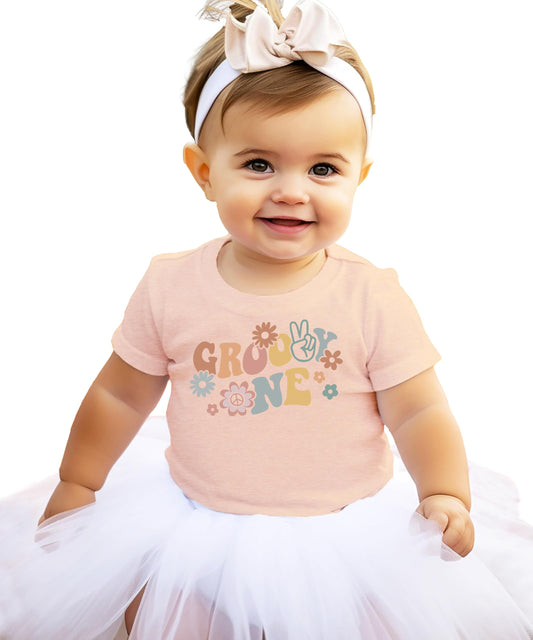 Close-up of groovy daisy One graphic print on infant birthday tee