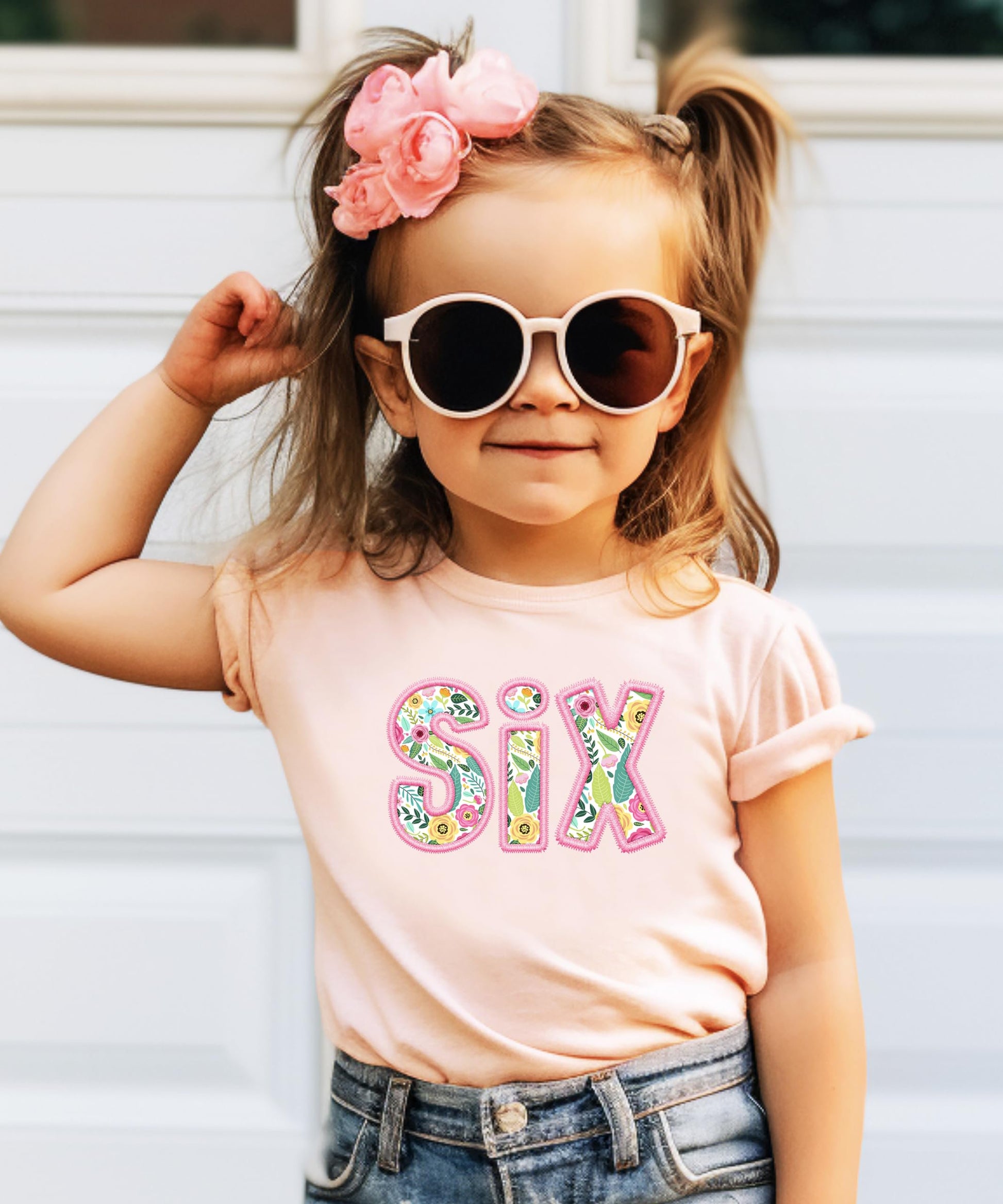 Flat lay of peach youth birthday tee featuring SIX floral design for girl turning 6