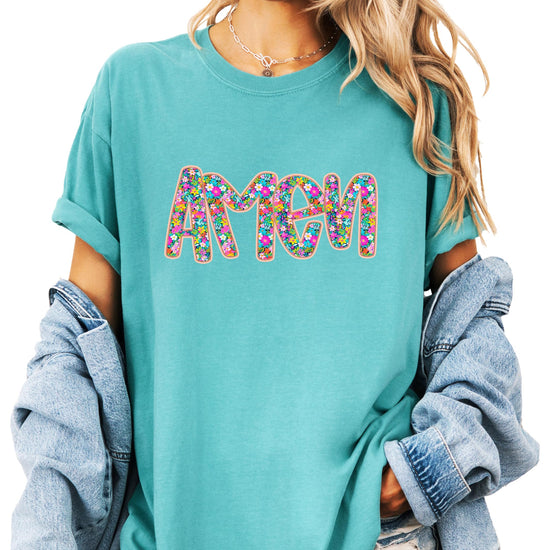 Close-up of floral Amen print on women's graphic tee showing vibrant colors and print detail