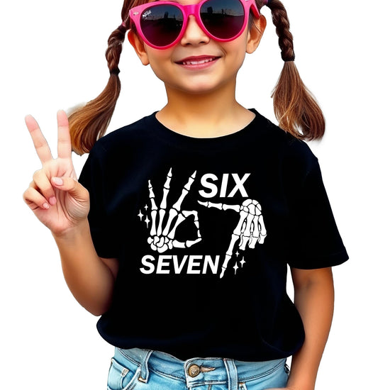 Close-up of six seven skeleton hand Halloween meme print on black shirt showing print quality