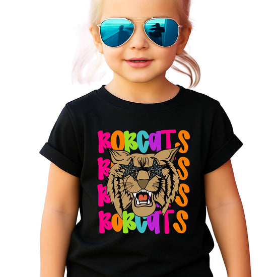 Colorful Bobcats wavy school spirit graphic tee with retro mascot wearing star sunglasses, natural shirt