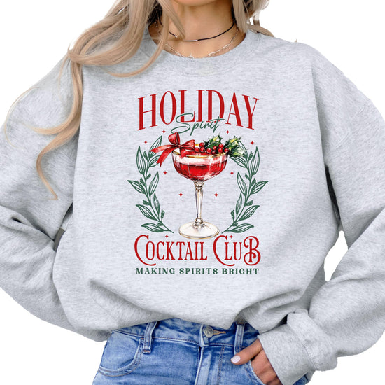 Close-up of Holiday Spirit Cocktail Club Christmas sweatshirt graphic print on gray fabric