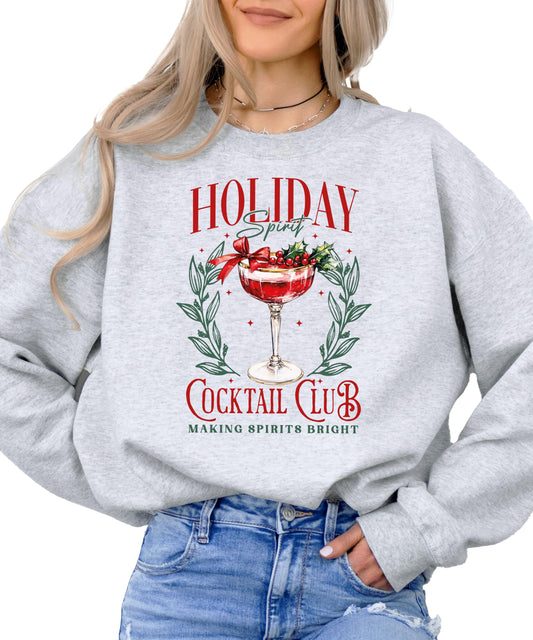 Close-up of Holiday Spirit Cocktail Club Christmas sweatshirt graphic print on gray fabric