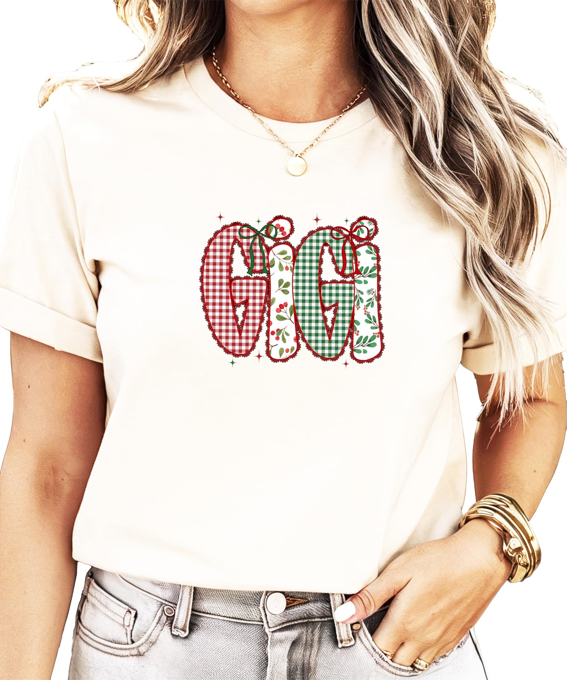 Close-up of faux lace ink-printed holiday design with holly and red bow details on Christmas tee