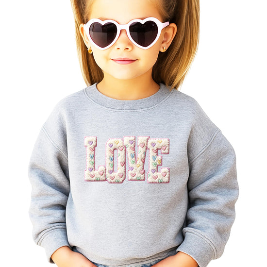 Front view of women's pink Valentine's Day sweatshirt with retro LOVE graphic print