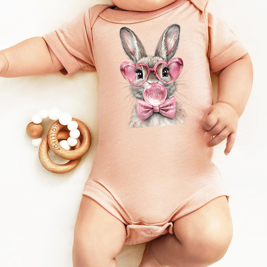 Easter bunny bubblegum onesie for baby girls laid flat on neutral background showing full design