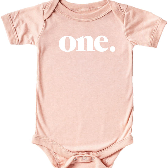 Baby wearing Bold One 1st birthday bodysuit in mauve — front view of birthday outfit