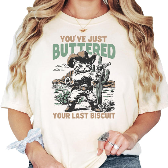 Full front view of funny cowboy cat saying t-shirt in ivory color for women
