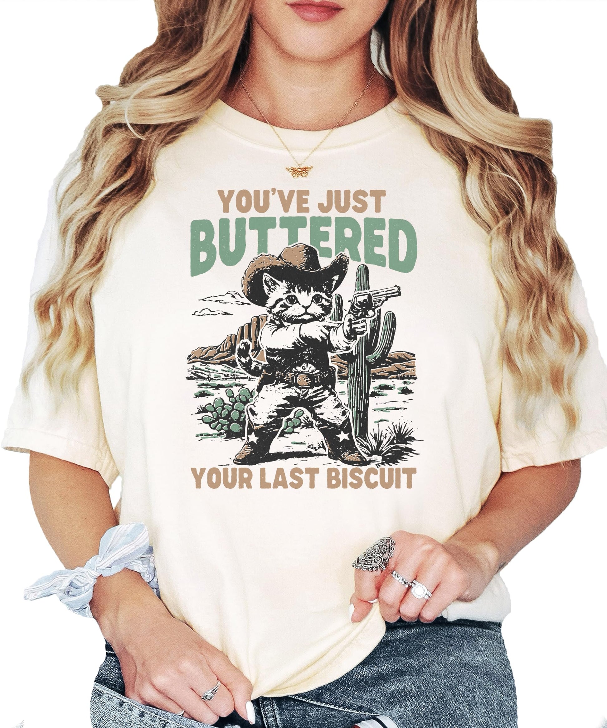 Full front view of funny cowboy cat saying t-shirt in ivory color for women