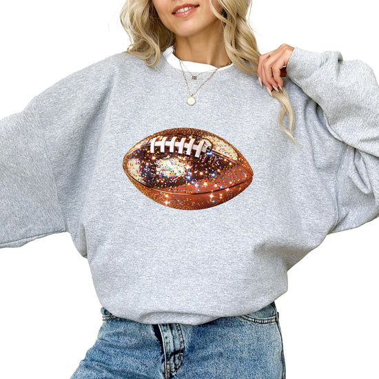 Women's white pullover sweatshirt with glitter football graphic for game day