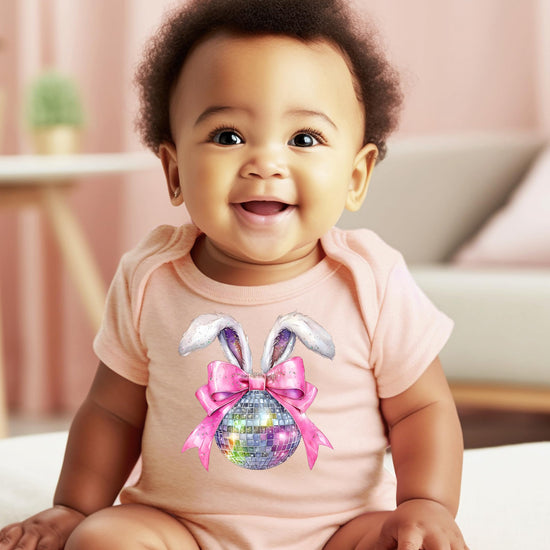 Close-up of Olive Loves Apple disco bunny Easter one-piece onesie with pink bow and glitter disco ball print