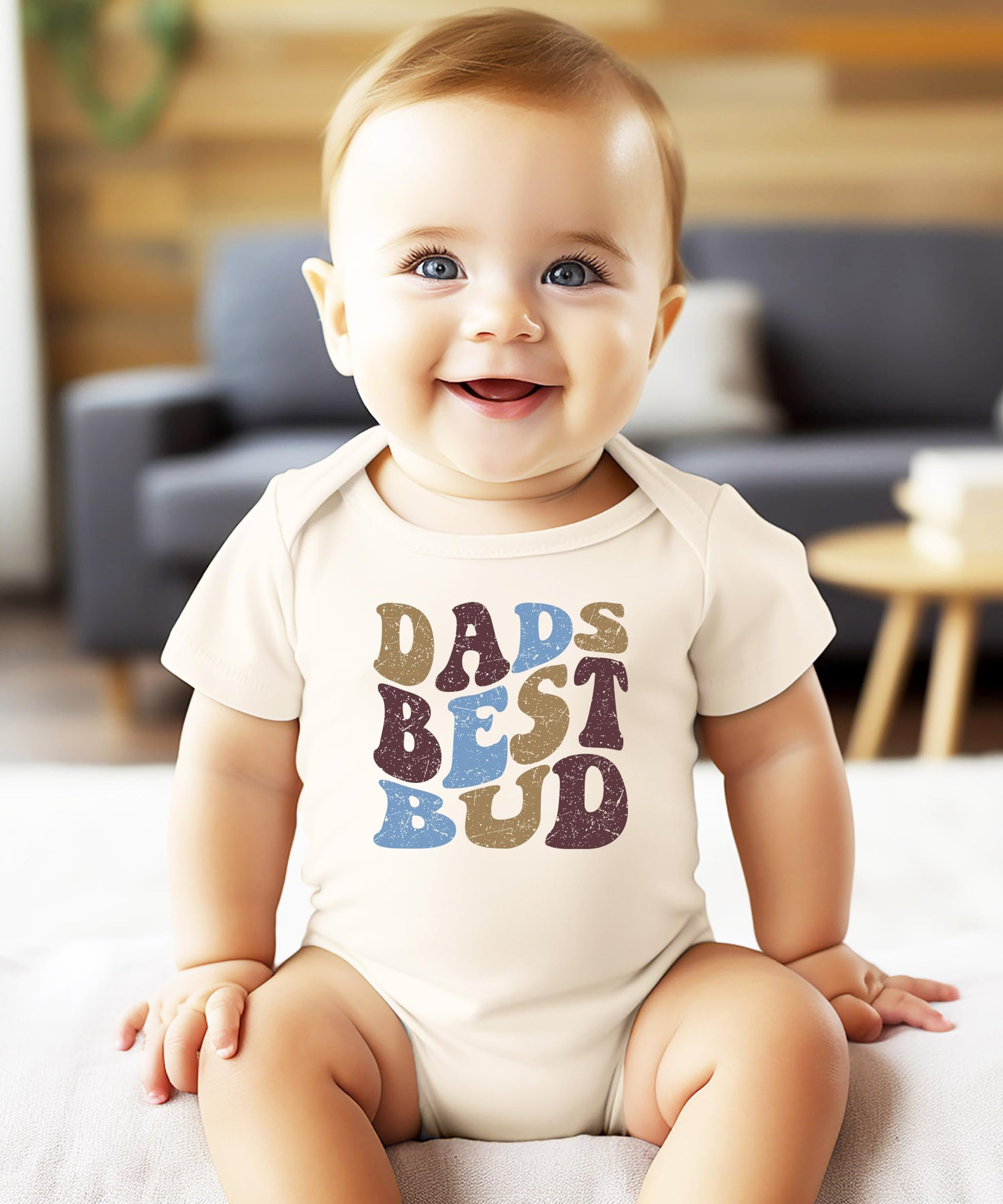 Flat lay of Dad's Best Bud baby bodysuit with retro font design for boys