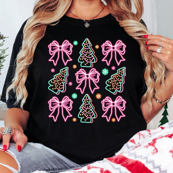 Side or lifestyle view of women's black festive Christmas graphic tee with neon gift bows and trees