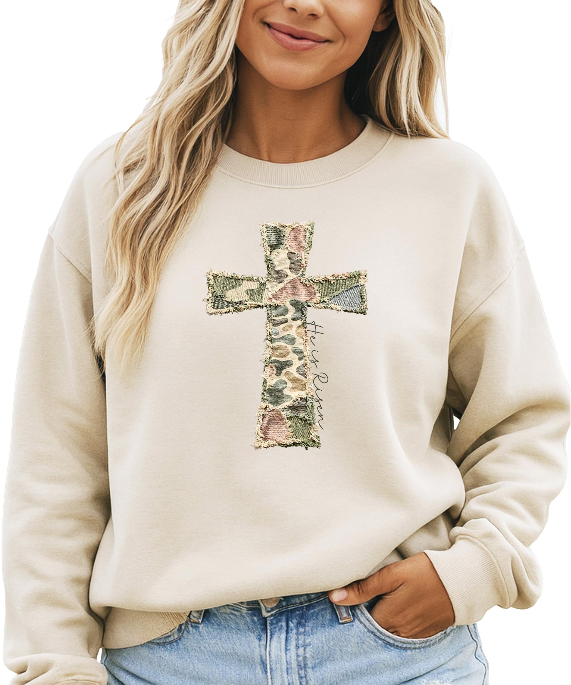 Close-up of ink-printed He Is Risen cross graphic on camo women's pullover sweatshirt