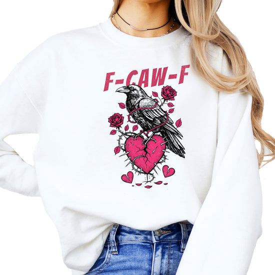Women's white crewneck sweatshirt with black crow over a broken heart and F-Caw-F text graphic