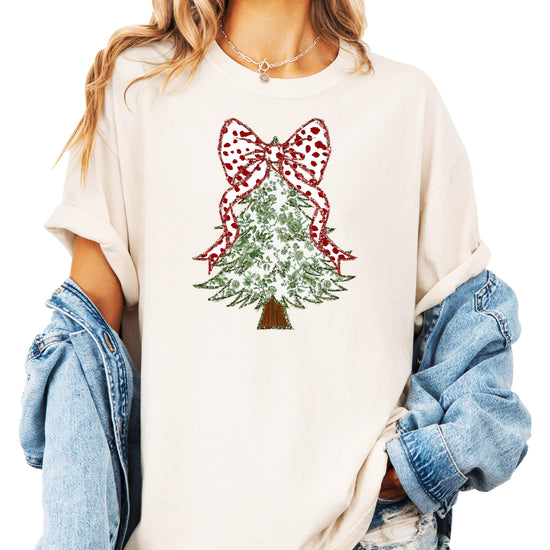 Full-length view of women's holiday graphic tee with faux glitter floral Christmas tree and red bow