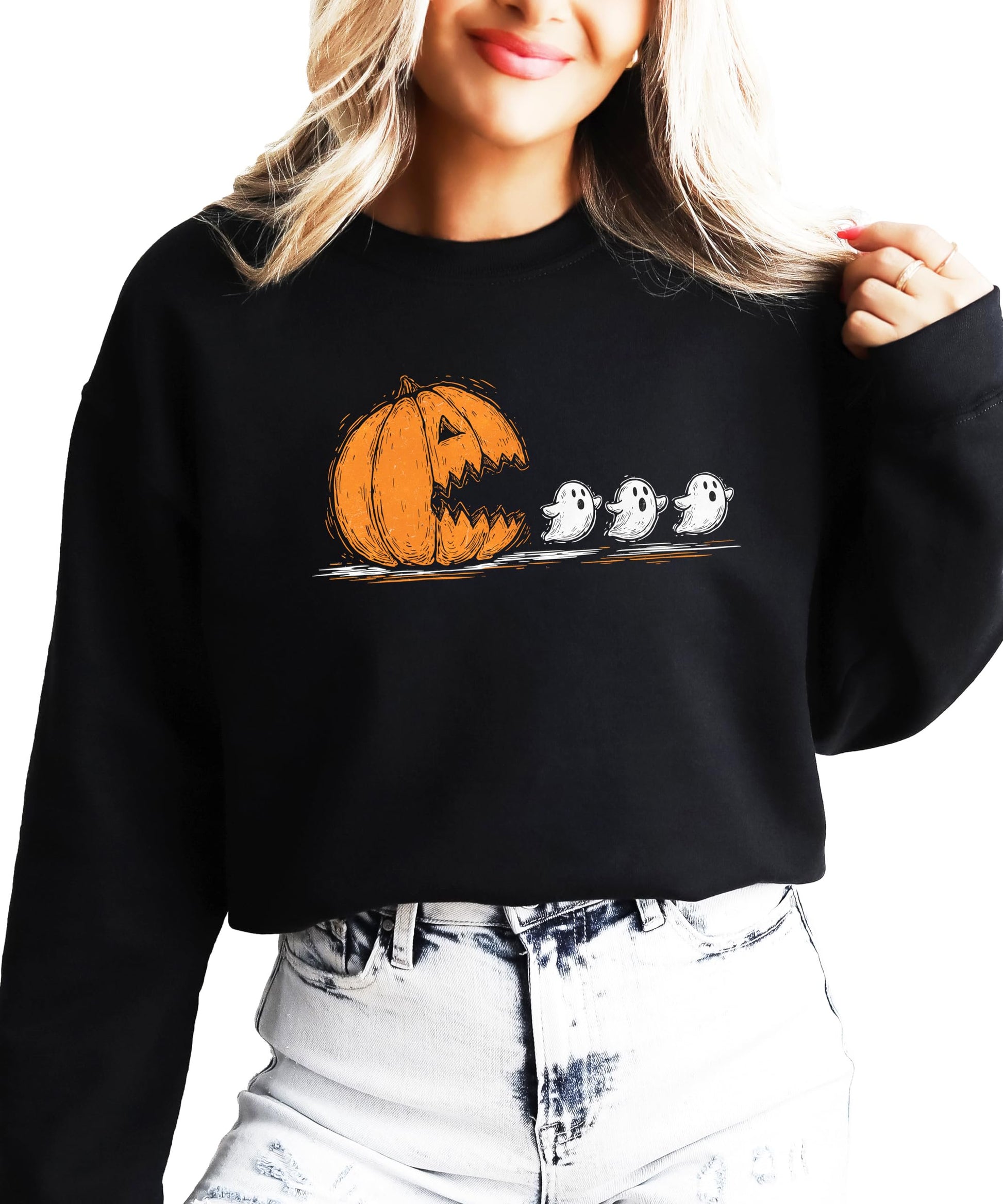Teen wearing a cute pumpkin ghost Halloween sweatshirt in a fall outdoor setting