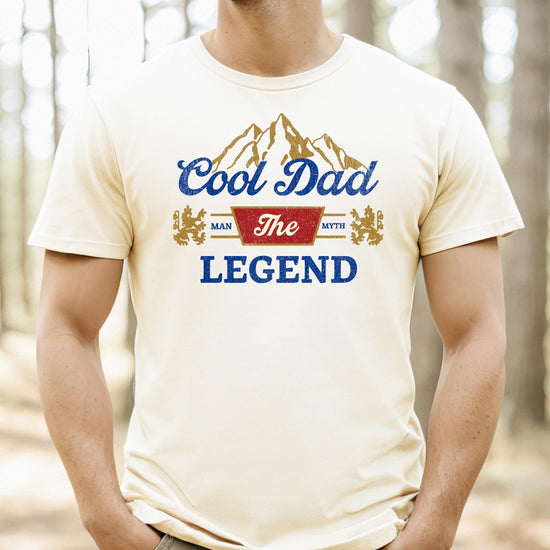 Close-up of Man Myth Legend typography and mountain graphic print on black tee