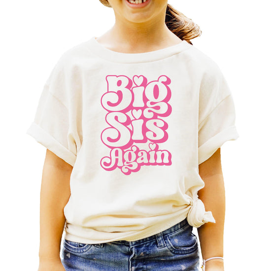 Kids natural tee with groovy pink 'Big Sis Again' retro graphic and heart details