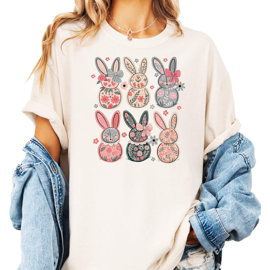Styled flat lay of ivory women's retro floral bunny Easter tee with spring accessories