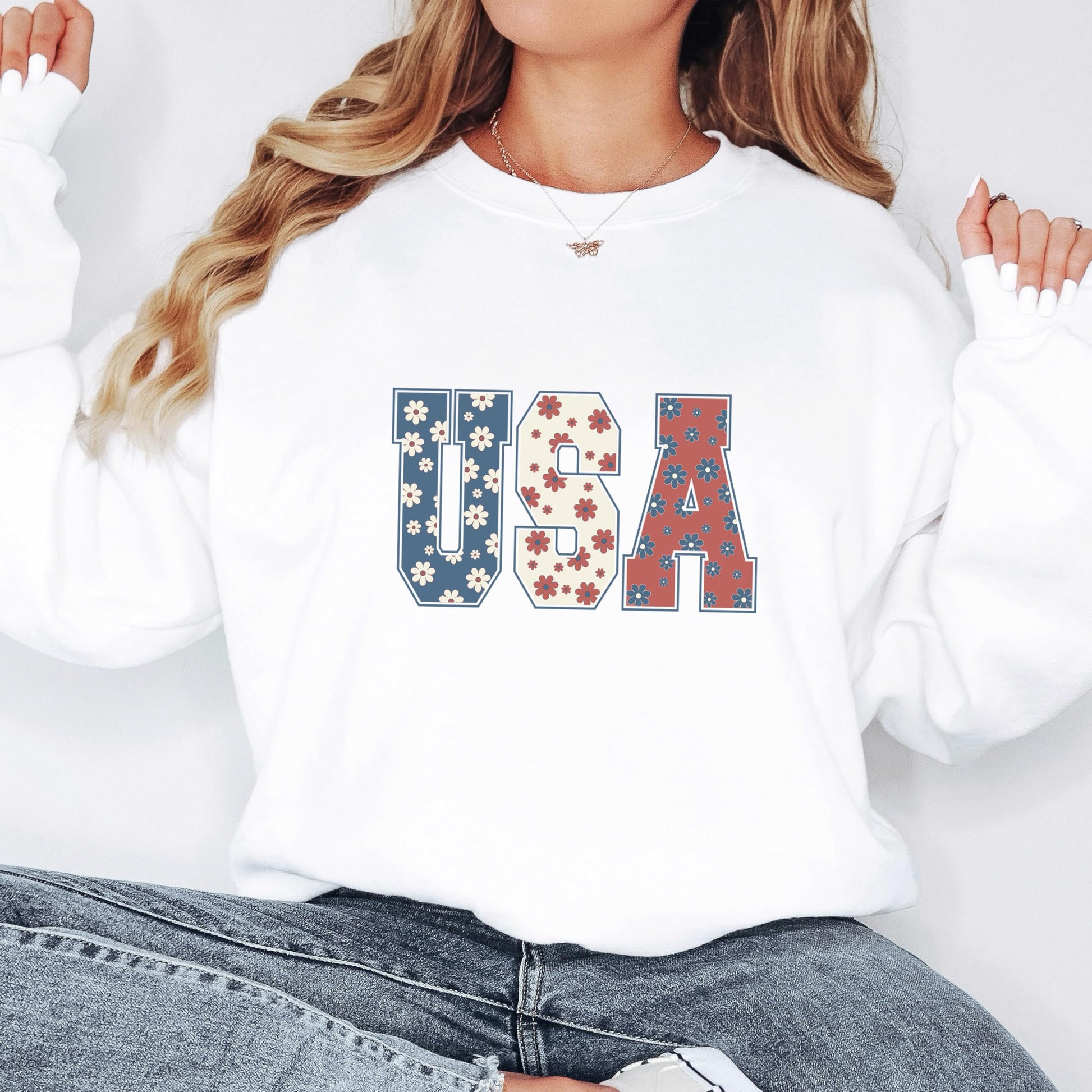 Side view of women's white patriotic sweatshirt with floral American flag inspired design