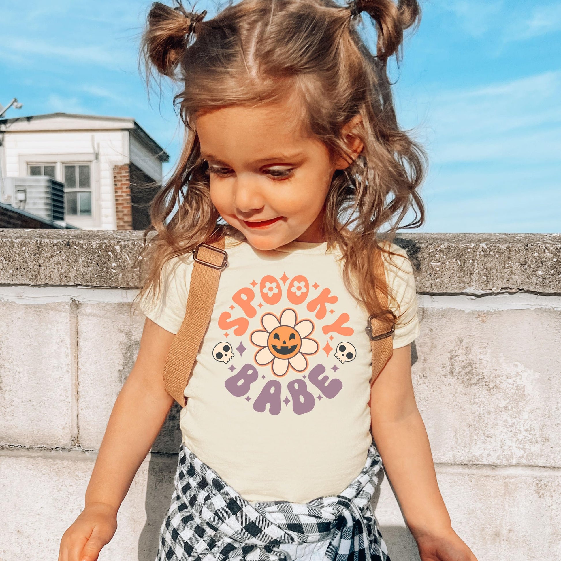 Girls peach Halloween shirt with Spooky Babe daisy pumpkin design, front view
