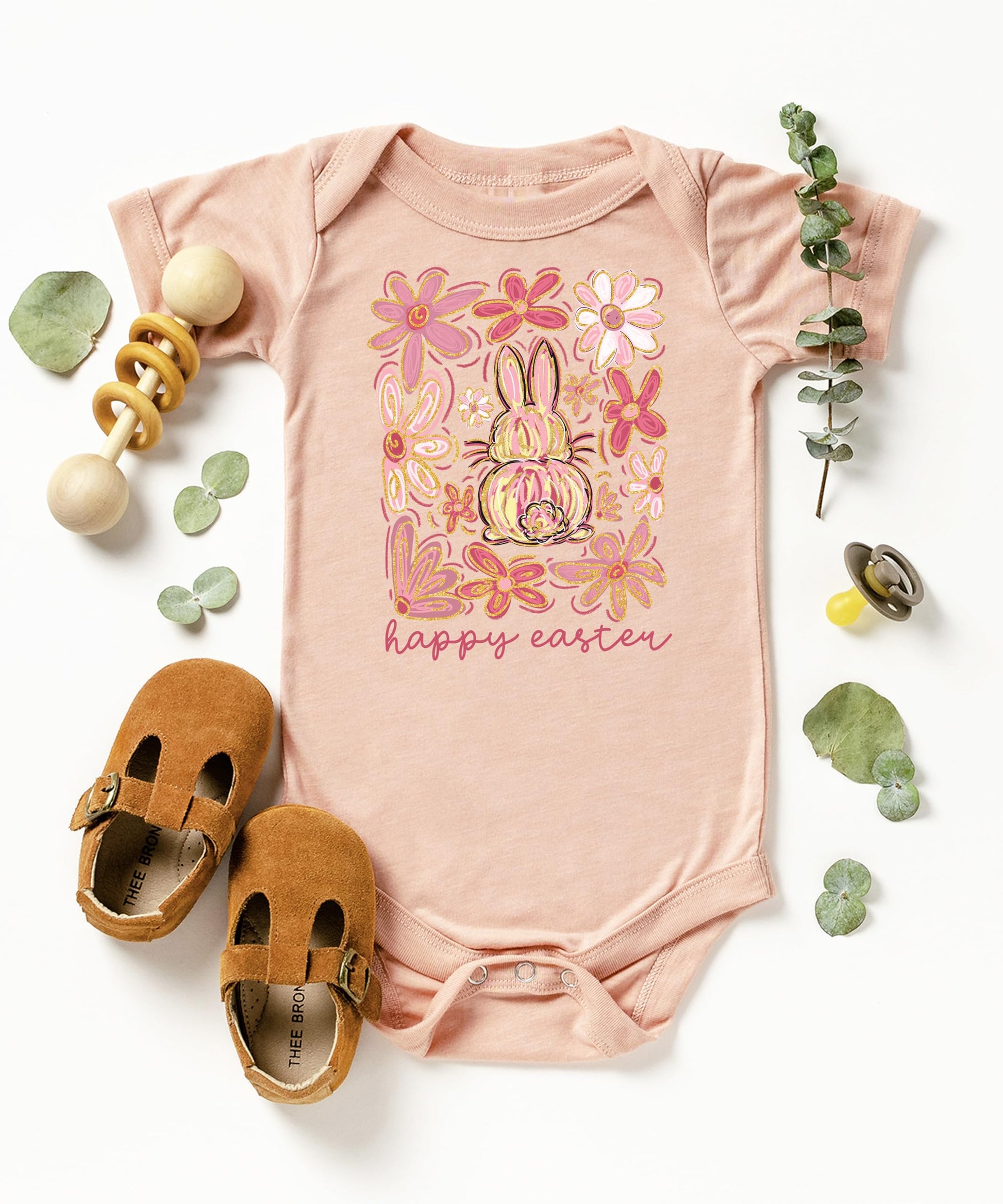 Olive Loves Apple boho Easter baby bodysuit hanging display with spring floral bunny design