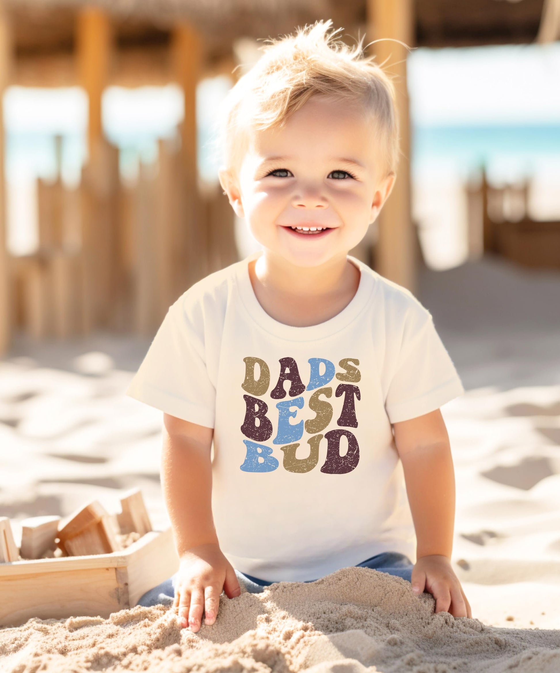 Toddler wearing retro Dad's Best Bud natural graphic tee, front view