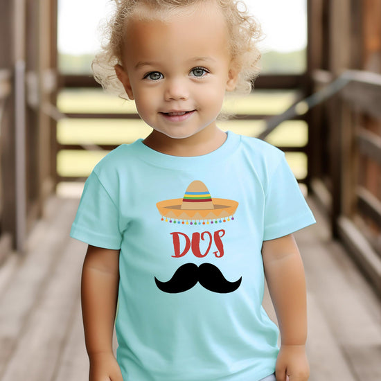 Side view of toddler wearing Dos 2nd birthday fiesta shirt