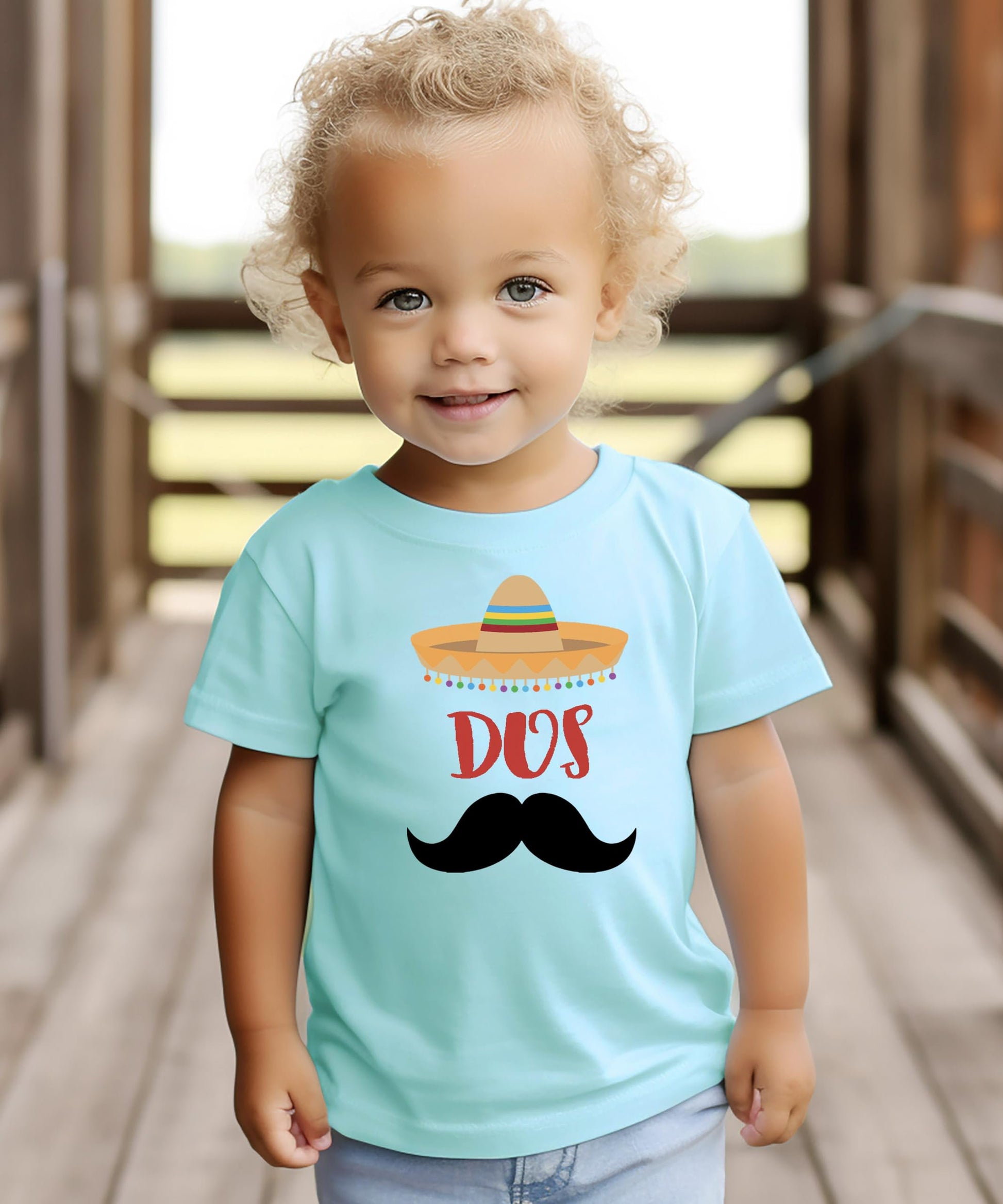 Side view of toddler wearing Dos 2nd birthday fiesta shirt