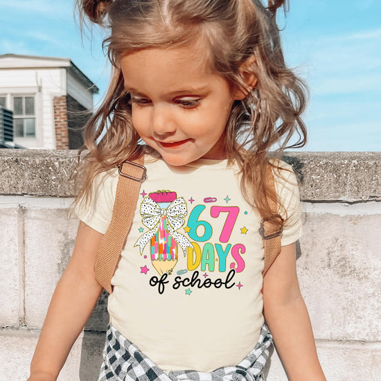 Detail shot of vibrant 6-7 meme coquette pencil print on soft kids' school t-shirt