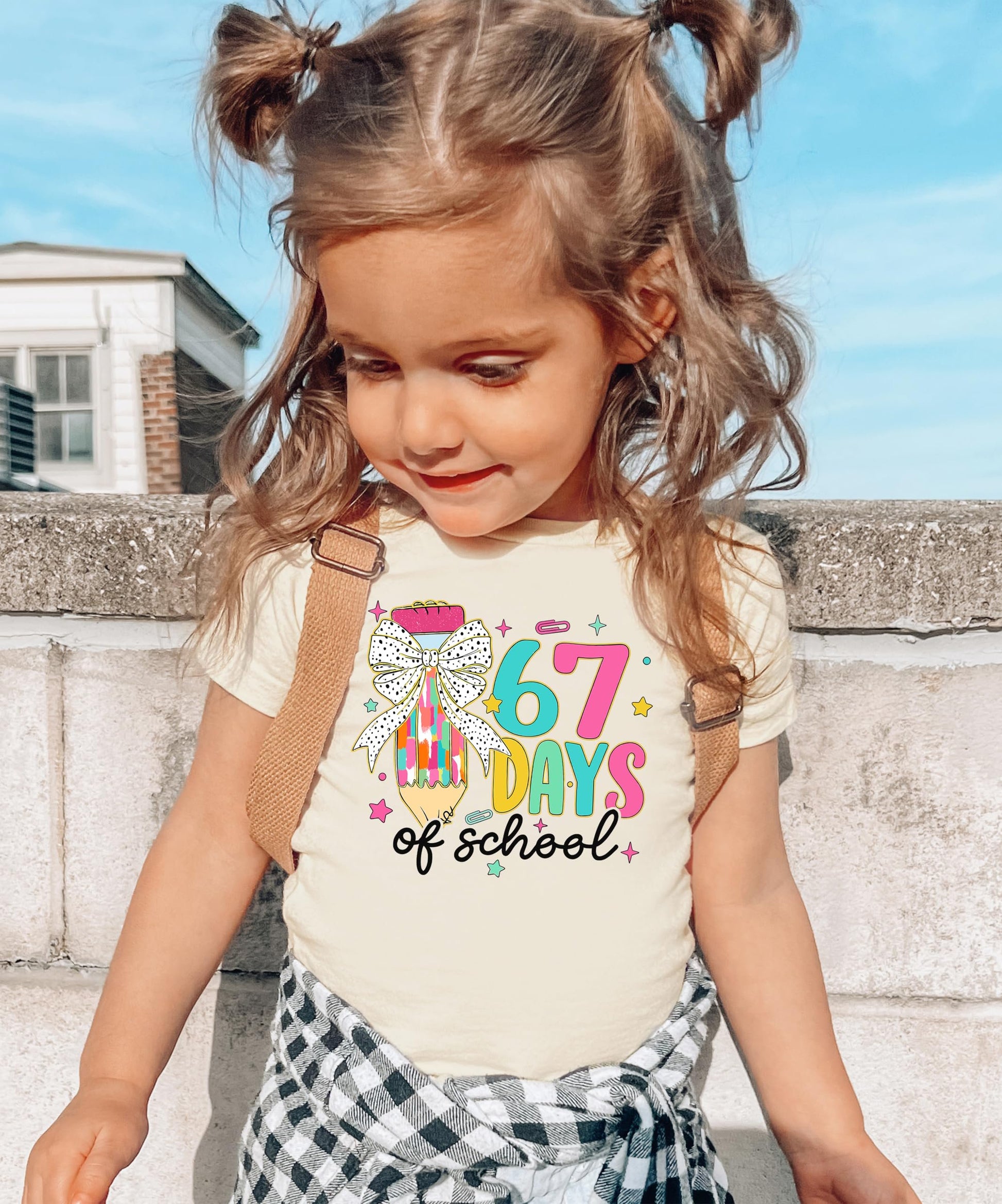 Detail shot of vibrant 6-7 meme coquette pencil print on soft kids' school t-shirt