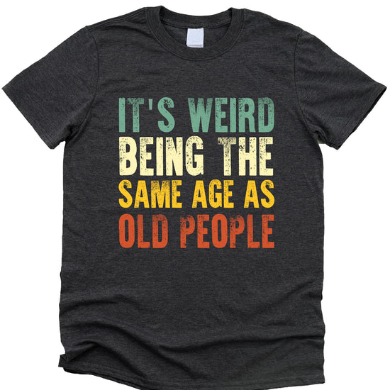 Flat lay of dark gray heather funny men's graphic tee with aging humor design